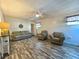 Comfortable living room with cozy seating and wood-look floors offers a relaxing space at 25292 Ne 132Nd Ln, Fort Mc Coy, FL 32134