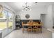 Dining area with modern light fixture and backyard views through sliding glass doors at 2705 Sw 156Th Lane Rd, Ocala, FL 34473