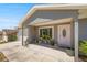 Inviting front porch with a pink door, swing, plants, and ample space for outdoor seating at 2705 Sw 156Th Lane Rd, Ocala, FL 34473