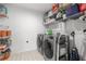 Organized laundry room with modern washer, dryer, and shelving for efficient storage at 2705 Sw 156Th Lane Rd, Ocala, FL 34473