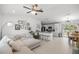 Spacious open-concept living room with a comfortable sectional sofa and view into the modern kitchen at 2705 Sw 156Th Lane Rd, Ocala, FL 34473