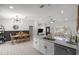 Open-concept living space with a modern kitchen, dining area, and comfortable seating area at 2705 Sw 156Th Lane Rd, Ocala, FL 34473