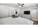 Spacious main bedroom with a large bed, dresser, and access to a connected bathroom at 2705 Sw 156Th Lane Rd, Ocala, FL 34473