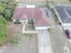 An aerial view showcasing a home's roof with solar panels, surrounded by a landscaped yard and neighboring houses at 2730 Sw 162Nd Street Rd, Ocala, FL 34473