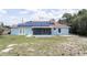 Aerial view of a backyard with screened in porch and energy-efficient solar panels on the roof at 2730 Sw 162Nd Street Rd, Ocala, FL 34473