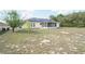 Spacious backyard featuring a screened patio and solar panels on the roof at 2730 Sw 162Nd Street Rd, Ocala, FL 34473