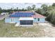 Backyard showing solar panels on roof and a screened in porch at 2730 Sw 162Nd Street Rd, Ocala, FL 34473