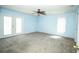 Bright and airy bedroom features a ceiling fan, carpet, and a glass door to the rear yard at 2730 Sw 162Nd Street Rd, Ocala, FL 34473