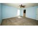 Spacious bedroom boasts natural light, plush carpeting, and a ceiling fan for added comfort at 2730 Sw 162Nd Street Rd, Ocala, FL 34473