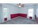 Cozy bedroom features carpet, stylish accent wall, a ceiling fan, and large windows with curtains at 2730 Sw 162Nd Street Rd, Ocala, FL 34473
