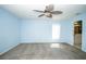 Airy bedroom boasts plush carpeting, natural light, a ceiling fan, and an en-suite bathroom at 2730 Sw 162Nd Street Rd, Ocala, FL 34473