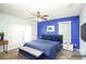 Stylish bedroom features a blue accent wall, ceiling fan, and ample natural light at 2730 Sw 162Nd Street Rd, Ocala, FL 34473