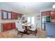 Cozy dining room with wood cabinets, modern appliances, and a table with seating for six at 2730 Sw 162Nd Street Rd, Ocala, FL 34473