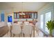 Formal dining room with wood floors, elegant light fixture, built-in cabinets, and walk out to the back patio at 2730 Sw 162Nd Street Rd, Ocala, FL 34473