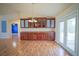 Dining area with wood floors, cabinets with glass doors, and access to the patio at 2730 Sw 162Nd Street Rd, Ocala, FL 34473