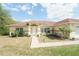 Charming home featuring a well-manicured lawn, walkway, and a decorative front door at 2730 Sw 162Nd Street Rd, Ocala, FL 34473
