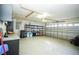 Spacious garage with garage door, overhead lighting, and convenient shelving units at 2730 Sw 162Nd Street Rd, Ocala, FL 34473
