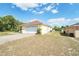 Home exterior view highlighting the attached two-car garage and manicured lawn at 2730 Sw 162Nd Street Rd, Ocala, FL 34473