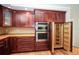 Gourmet kitchen features custom wood cabinetry, stainless steel appliances, and convenient pull-out shelving at 2730 Sw 162Nd Street Rd, Ocala, FL 34473
