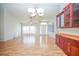 Expansive living room featuring wood floors, high ceilings, large windows, and a built-in cabinet with display shelves at 2730 Sw 162Nd Street Rd, Ocala, FL 34473