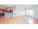 Spacious open-concept living room showcasing hardwood floors and views into the kitchen at 2730 Sw 162Nd Street Rd, Ocala, FL 34473