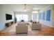 Bright living room featuring a neutral color palette, wood floors, and large windows that bring in natural light at 2730 Sw 162Nd Street Rd, Ocala, FL 34473