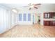 Open-concept living area with wood floors, high ceilings, and ample natural light creates an inviting and airy space at 2730 Sw 162Nd Street Rd, Ocala, FL 34473