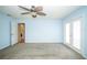 Light and bright main bedroom with ceiling fan, carpeted floor, a utility area, and french doors to the outside at 2730 Sw 162Nd Street Rd, Ocala, FL 34473