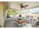 Relaxing covered patio with comfortable seating and a ceiling fan, perfect for outdoor enjoyment at 2730 Sw 162Nd Street Rd, Ocala, FL 34473