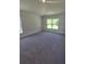 Large bedroom features plush carpeting and a window overlooking a serene view at 3180 Ne 46Th Ave, Ocala, FL 34470