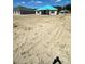 New construction home with a large front yard and blue-covered roof, situated on a spacious lot at 3180 Ne 46Th Ave, Ocala, FL 34470