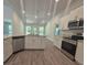 Modern kitchen features stainless steel appliances, granite countertops and wood-look flooring at 3180 Ne 46Th Ave, Ocala, FL 34470