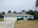 Charming single-story home with a two-car garage, green lawn and tidy landscaping at 38 Laurel Ct, Ocala, FL 34480
