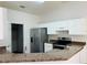 Bright kitchen featuring stainless steel appliances, granite counters, and white cabinetry at 38 Laurel Ct, Ocala, FL 34480