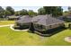 Aerial view of the well-maintained home, lush landscaping, and expansive green lawn at 4424 Se 14Th St, Ocala, FL 34471
