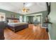 Spacious main bedroom with a king bed, connected seating area, and a vaulted ceiling with fan at 4424 Se 14Th St, Ocala, FL 34471