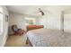 Comfortable bedroom featuring a ceiling fan, plush carpet, and bright natural light at 4424 Se 14Th St, Ocala, FL 34471