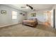 Spacious bedroom with neutral walls, carpeted floors, ceiling fan, and ample natural light at 4424 Se 14Th St, Ocala, FL 34471