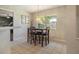 Breakfast area with window view and view into exercise area, and modern pendant lighting fixture at 4424 Se 14Th St, Ocala, FL 34471