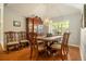 Elegant dining room featuring hardwood floors, a decorative chandelier, and a classic china cabinet at 4424 Se 14Th St, Ocala, FL 34471