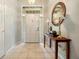 Bright foyer with tile flooring, a decorative mirror, and a view of the front door at 4424 Se 14Th St, Ocala, FL 34471