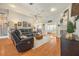 Open living room featuring hardwood floors, a ceiling fan, and comfortable leather furniture at 4424 Se 14Th St, Ocala, FL 34471