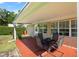 Covered patio with outdoor table and seating, offering a relaxing spot for outdoor dining and entertaining at 4424 Se 14Th St, Ocala, FL 34471