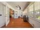 Bright sun room with wood floors, ceiling fan, lots of windows and access to the rest of the home and backyard at 4424 Se 14Th St, Ocala, FL 34471