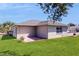 Backyard featuring a gray roof, a small patio and lush green lawn at 4716 Nw 34Th Pl, Ocala, FL 34482