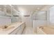 Spacious bathroom featuring a long vanity with dual sinks, walk-in shower and separate soaking tub at 4716 Nw 34Th Pl, Ocala, FL 34482
