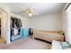 This cozy bedroom has a ceiling fan, a window with blinds, and carpeted floors at 4716 Nw 34Th Pl, Ocala, FL 34482