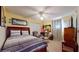 Comfortable bedroom features carpeted floors, ceiling fan, and charming decor at 4716 Nw 34Th Pl, Ocala, FL 34482