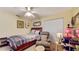 Comfortable bedroom features carpeted floors, ceiling fan, and charming decor at 4716 Nw 34Th Pl, Ocala, FL 34482