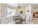 Cozy dining area with chandelier, view to patio through window, and tile flooring at 4716 Nw 34Th Pl, Ocala, FL 34482
